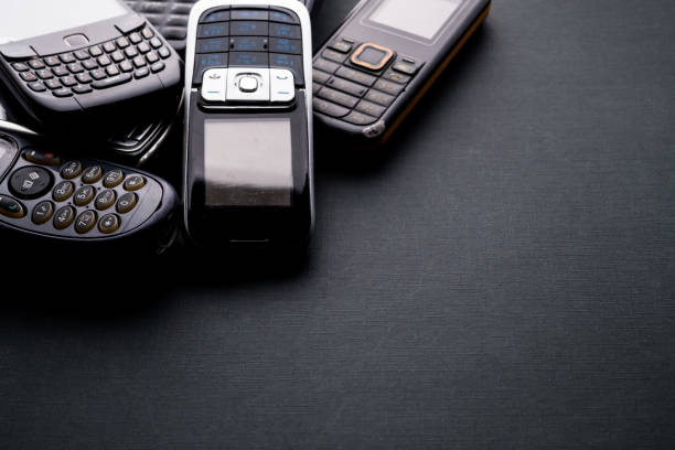istock Old and obsoleted cellphones on a black background. 1218516697