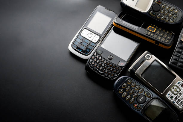istock Old and obsoleted cellphones on a black background. 1218516699