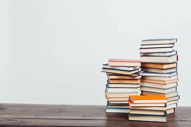 Photo of lots of stacks of educational books to teach in the library on a white background