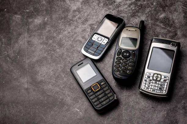 istock Many obsoleted cellphones on a grunge background. 1218518113