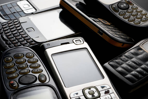 istock Old and obsoleted cellphones on a black background. 1218518141