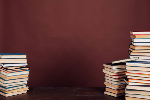 istock many stacks of educational books to study in the university library on a brown background 1218518874