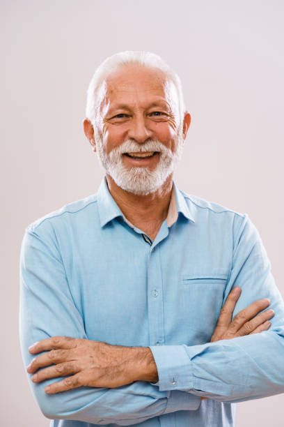Happy senior man Portrait of cheerful senior man who is looking at camera and smiling. one senior man only stock pictures, royalty-free photos & images