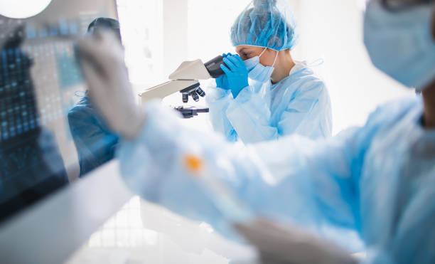 istock Scientists wearing full protective suit working in the laboratory 1218520190