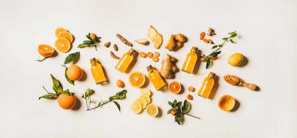Immune boosting natural vitamin health defending drink to resist virus Immune boosting natural vitamin health defending drink to resist virus. Flat-lay of fresh turmeric, ginger and citrus juice shots over white background, top view. Vegan Immunity system booster rocket booster photos stock pictures, royalty-free photos & images