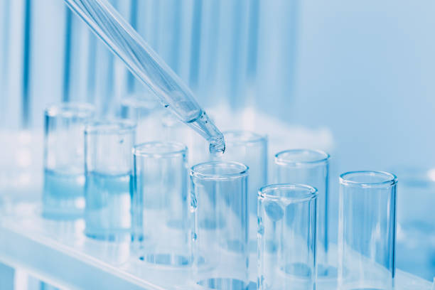 istock Laboratory glassware with a dropper dripping liquid into a test tube. scientific laboratory test tubes, laboratory equipment 1218521759