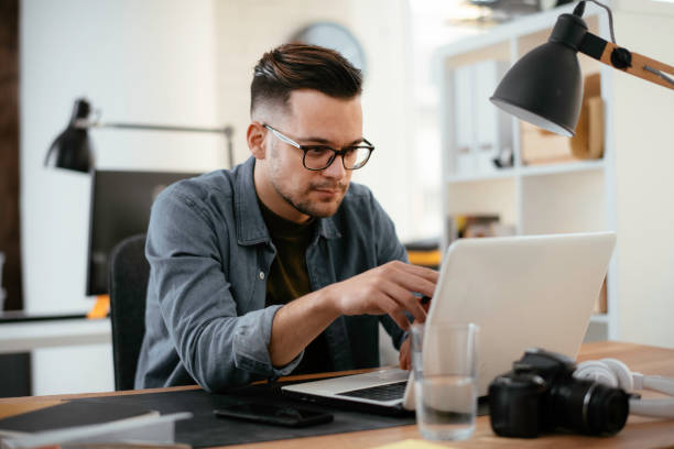 istock Young handsome businessman working in office. 1218521934