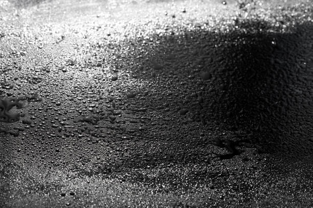 istock drops of water are sprayed on a black reflective glass 1218523302