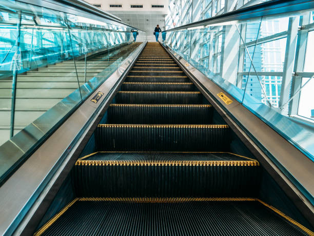 istock Modern escalator with staircases in metro or mall, perspective 1218524287