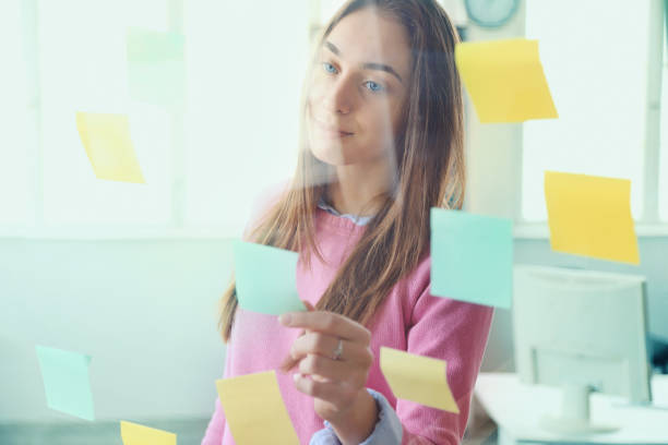 istock Business woman looking at sticky notes 1218525725