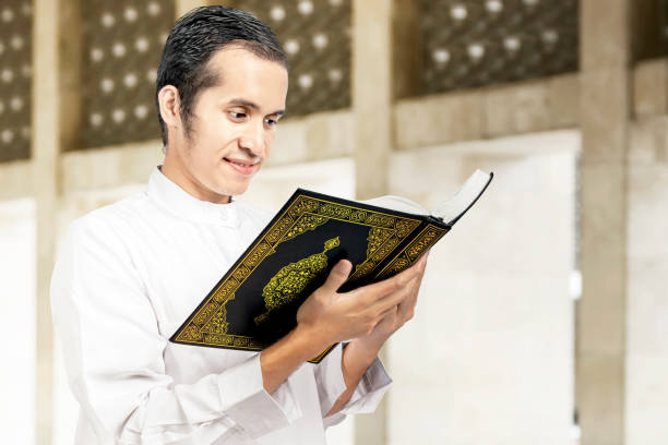 istock Asian Muslim man reading the Quran 1218526481