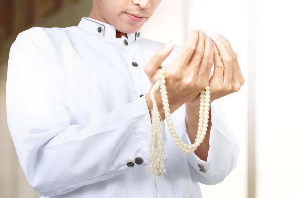 istock Asian Muslim man praying with prayer beads on his hands 1218526505