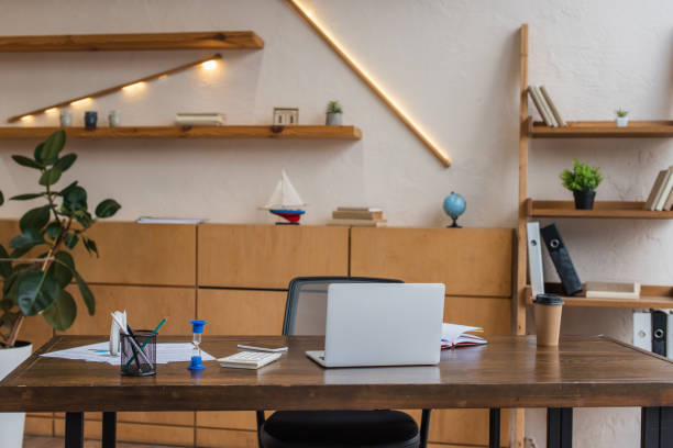 istock Table with laptop, hourglass and pen holder in office 1218526547