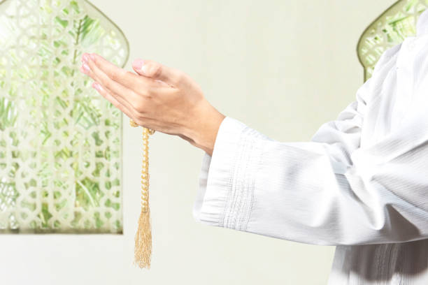 istock Muslim man praying with prayer beads on his hands 1218527324