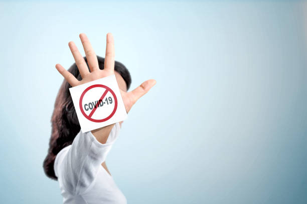 istock Asian woman showing stop hand gesture for coronavirus 1218527508
