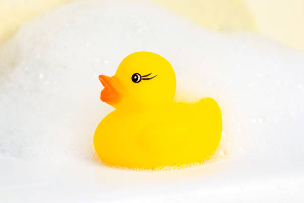 istock Rubber duck in the foam. minimally creative concept. bathing children 1218527553