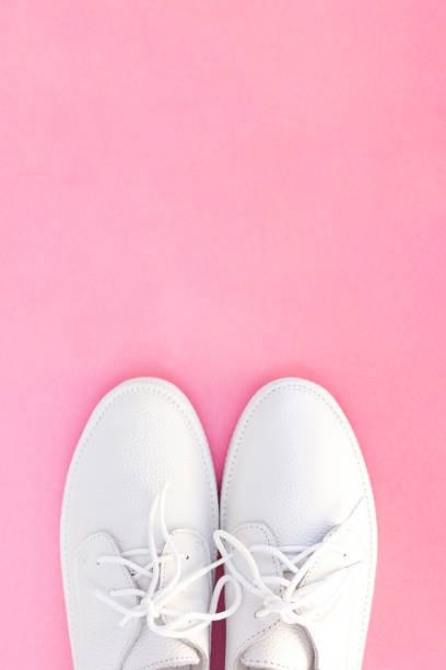 istock white sneakers on a pink background. view from above. copyspace. place for text 1218531059