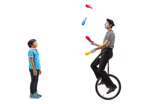 istock Boy watching a clown juggling on a unicycle 1218531109