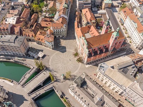 Aerial drone view of Preseren Squere and Triple Bridge over Ljubljanica river,Tromostovje, Ljubljana, Slovenia. Empty streets during corona virus pandemic social distancing measures.