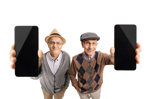 Two elderly gentlemen showing mobile phones to the camera isolated on white background