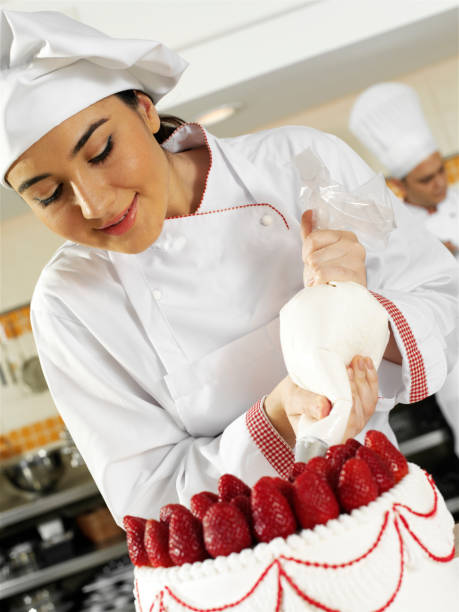 istock Female Chef Working On Strawberry Cake 1218533704