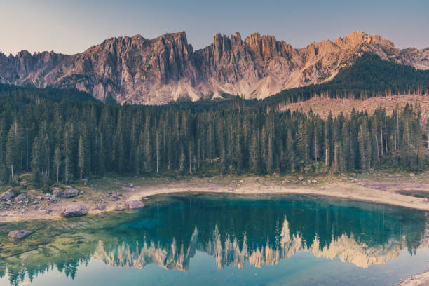 istock Mountain lake Carezza surrounded by pine forest and mountains. 1218533786