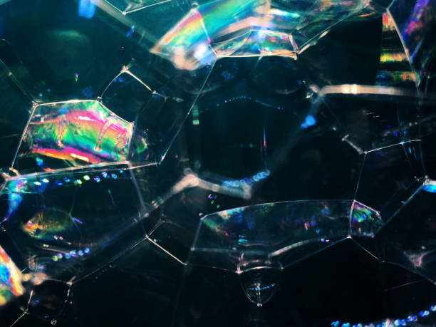 istock soap bubbles on dark background. noise film grain so conceived, background texture 1218535719