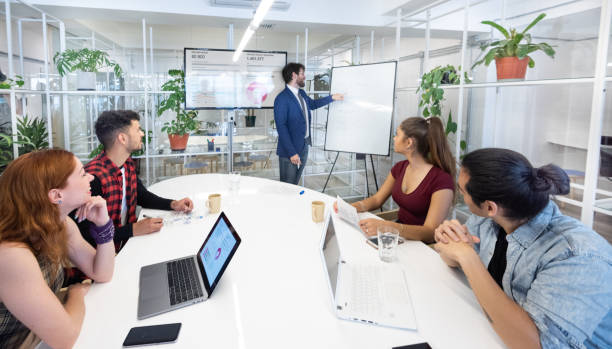istock Presentation in multi ethnic business team meeting, seen from outside through windows 1218537487
