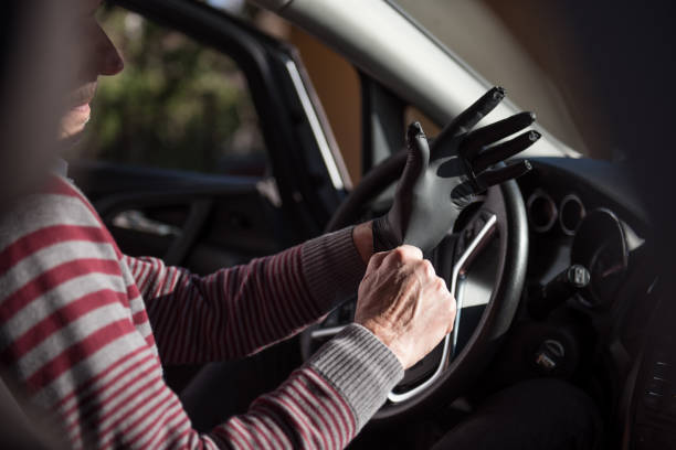 istock Senior man puts on protective gloves before driving 1218538205