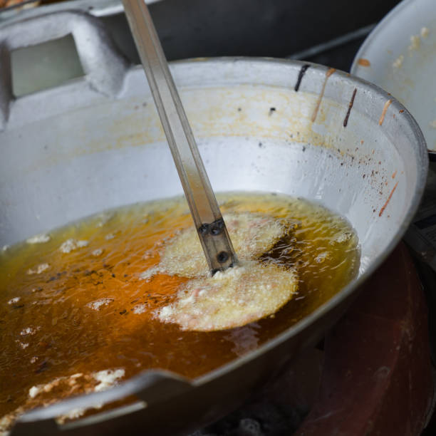istock Placing homemade thai peanut cookie into cooking oil 1218538257