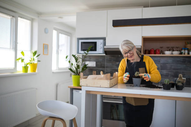 istock Woman working with plants at home 1218539376