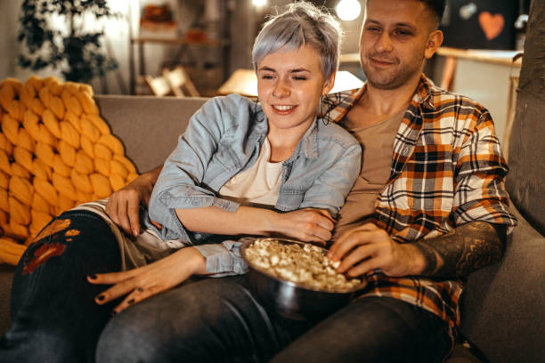 istock Couple eating popcorn while watching movie 1218539586