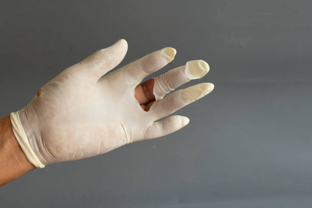 istock latex glove hand tear, on white background. 1218539775
