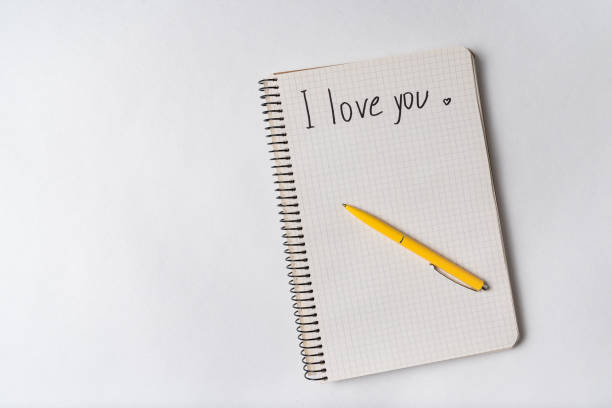istock I love you, inscription in notebook. Pen on notepad. White background, copy space. 1218539927