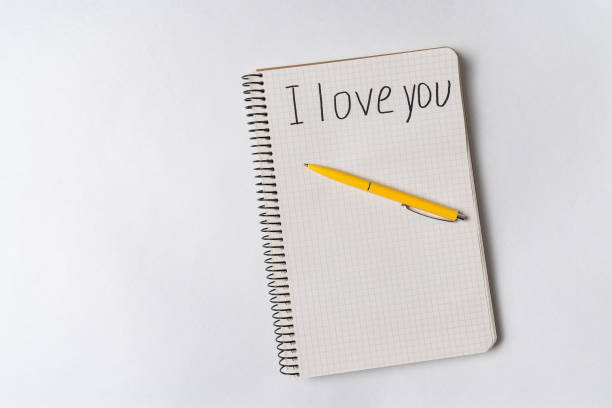 istock I love you, inscription in notebook. Message for loved. White background, copy space. 1218539938