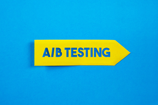 Yellow Sticky Paper With A/B Testing Message On Blue Background. Horizontal composition with copy space.