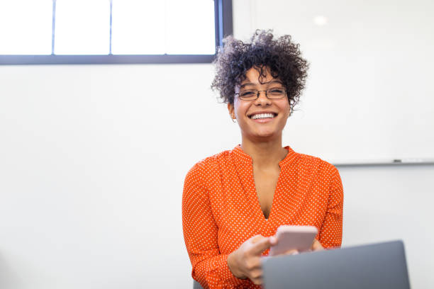 istock Young African Woman With Glasses Using Mobile Phone 1218542552