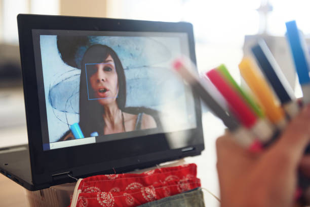 istock Woman doing a live video to show how to make creative cute protective masks 1218543835