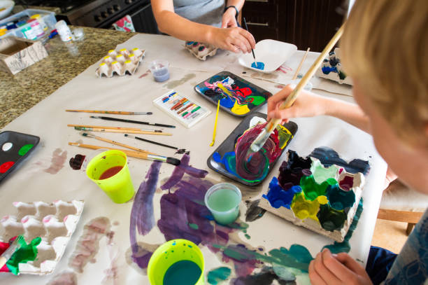 istock Home school art and craft class mixing colours 1218545988