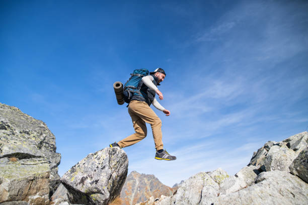 istock Mature man with backpack hiking in mountains in summer. 1218549727