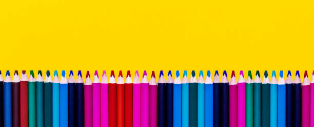 multicolored wooden pencils on yellow background. banner. - starting at the bottom imagens e fotografias de stock