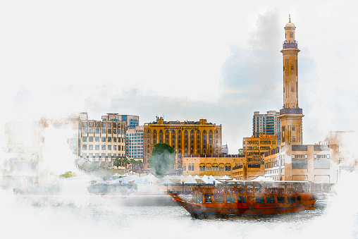 Dubai, UAE - March, 15. 2019 - the Creek is a river through Dubai on the banks of which are old city-like settlements. Here, the houses are not so high, the streets narrow and the main traffic takes place via ferries on the water. The large mosque with minaret is one of the eye-catching sights
