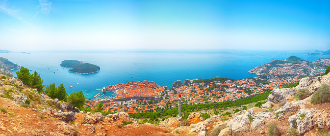 Aerial panoramic view of the old town of Dubrovnik with famous Cable Car on Srd mountain on a sunny day. Location:  Dubrovnik, Dalmatia, Croatia, Europe