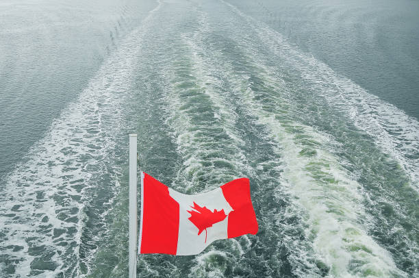 istock Canada flag on the ocean waves background. 1218552663