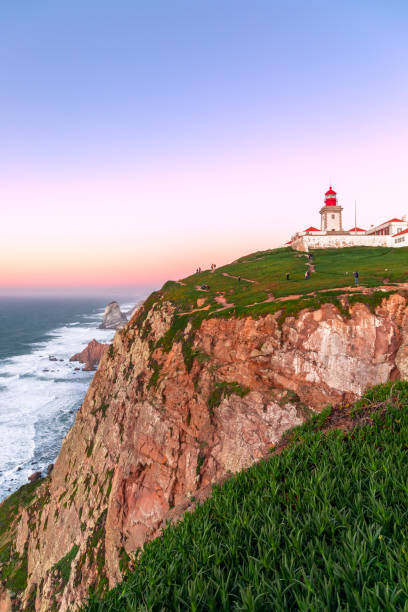 istock Cabo da Roca, Sintra, Portugal. Lighthouse and cliffs over Atlantic Ocean, the most westerly point of the European mainland at sunset. 1218554177