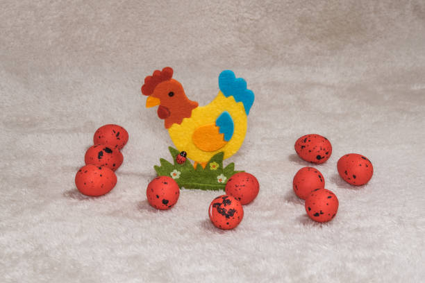istock Decorative holiday collection with painted Easter eggs & artificial chicken figurine. 1218554596