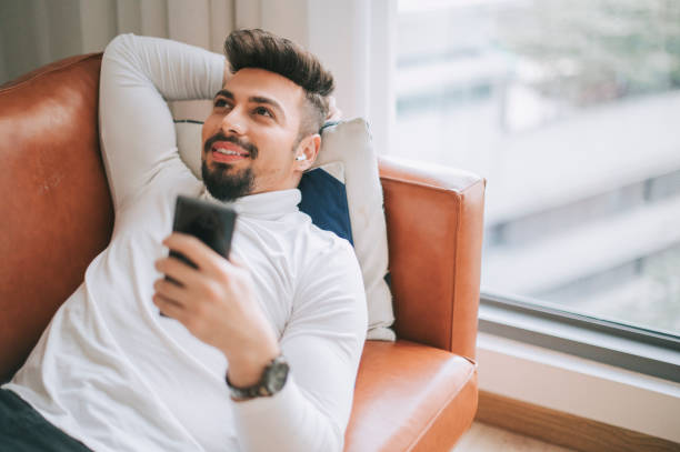 istock a middle eastern man lying down on sofa in living room relaxing taking a break in the afternoon 1218554813