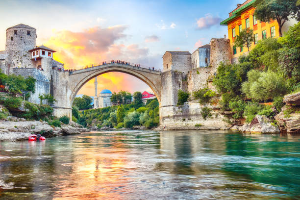 Famos Mostar bridge Fantastic Skyline of Mostar with the Mostar Bridge, houses and minarets, at sunset. Location: Mostar, Old Town, Bosnia and Herzegovina, Europe mostar stock pictures, royalty-free photos & images