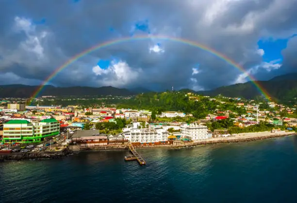 Beautiful rainbow with colourful landscape with cruise port and skyline, Roseau, Dominica.