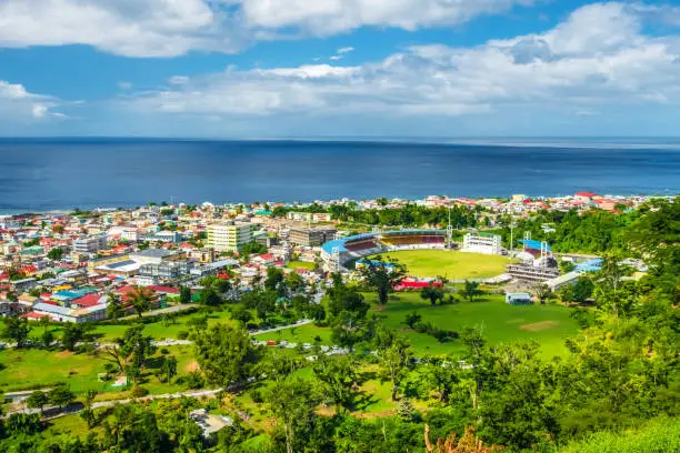 Bright and colourful aerial view of coastline and buildings of Roseau, Dominica.